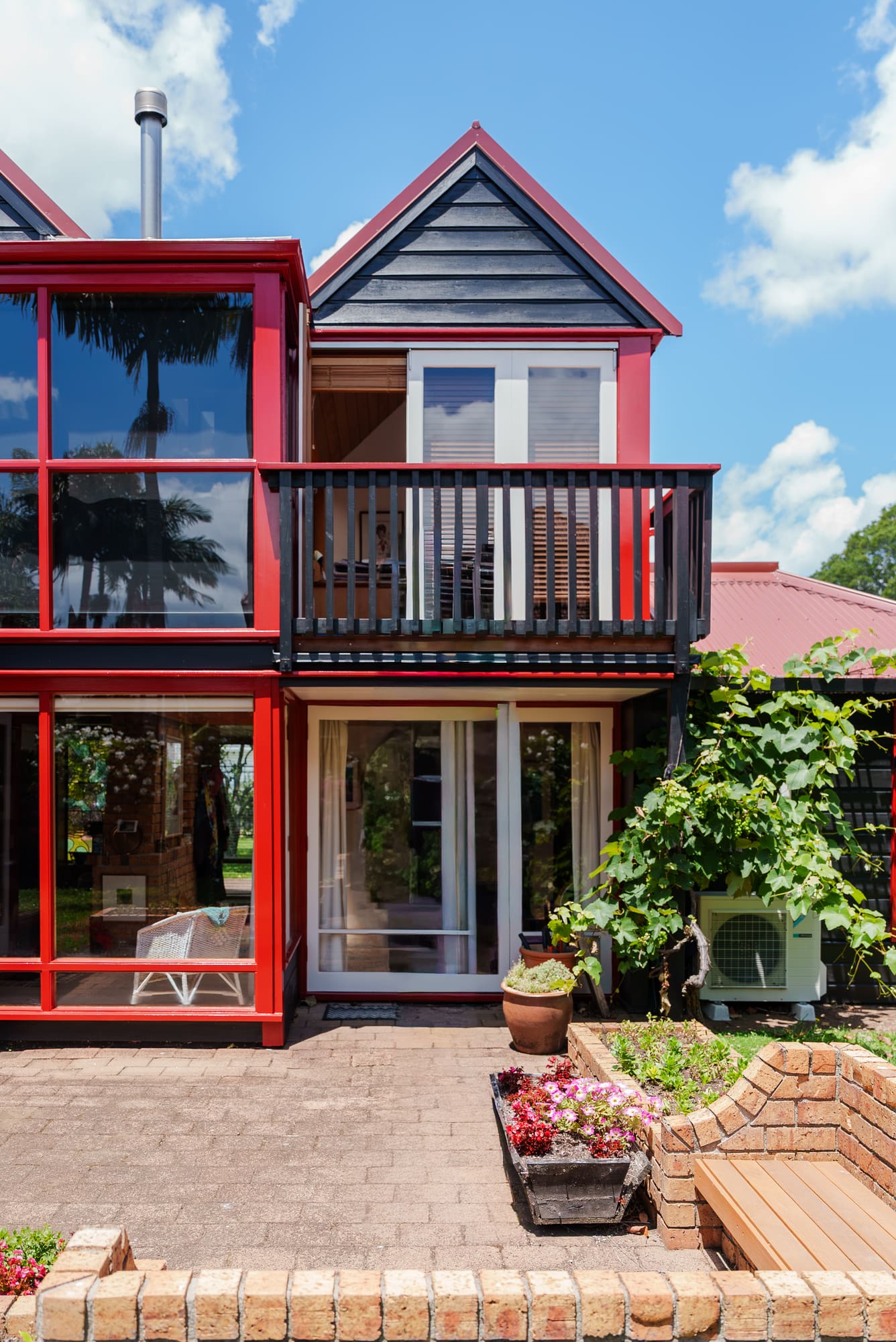 The courtyard side of the house with brick paving and planters.
