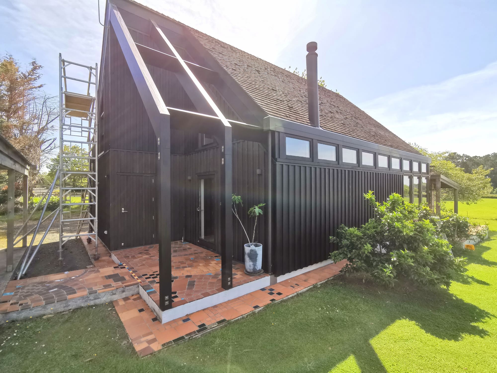 The studio mid-project, with mobile scaffolding standing against the gable end.